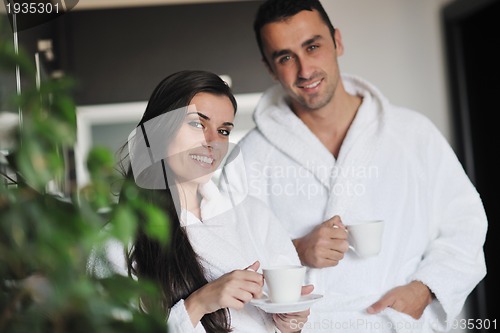 Image of Young love couple taking fresh morning cup of coffee