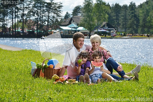 Image of Happy family playing together in a picnic outdoors