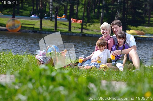 Image of Happy family playing together in a picnic outdoors