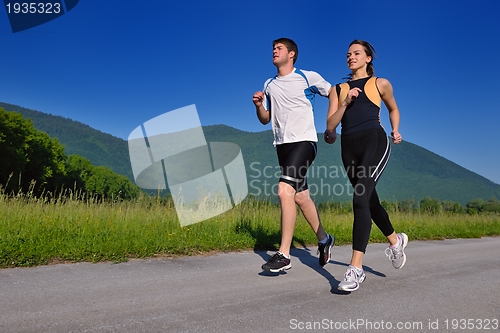 Image of Young couple jogging