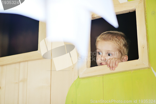 Image of happy child in a window
