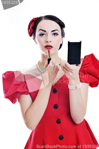 Image of beautiful young woman applying makeup