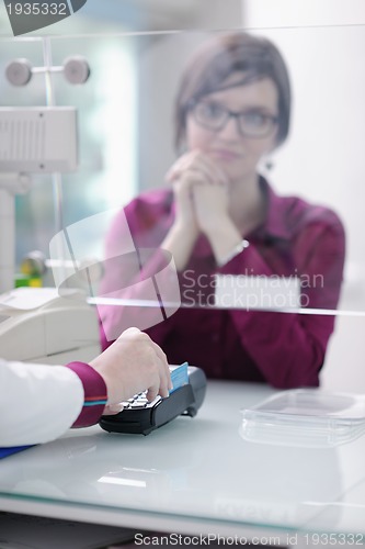 Image of pharmacist suggesting medical drug to buyer in pharmacy drugstor