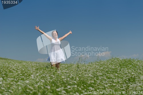 Image of Young happy woman in green field