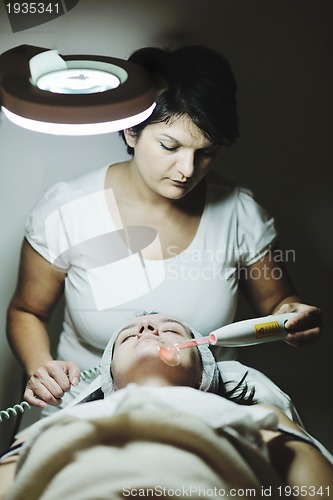 Image of woman with facial mask in cosmetic studio