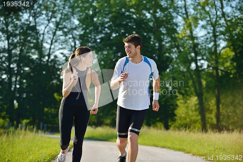 Image of Young couple jogging at morning