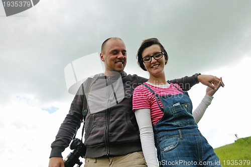 Image of Portrait of romantic young couple smiling together outdoor