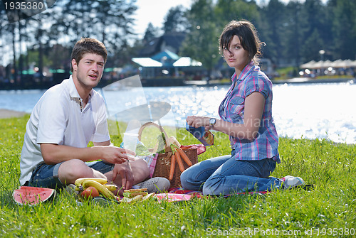Image of happy young couple having a picnic outdoor