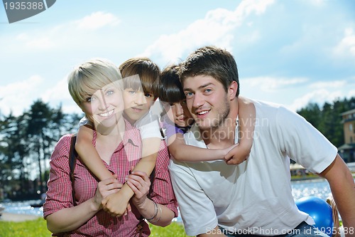 Image of happy young family have fun outdoors