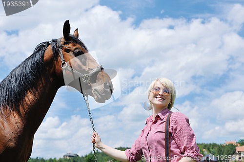 Image of happy woman  ride  horse