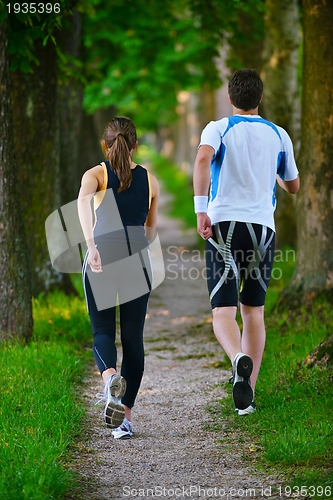 Image of Young couple jogging