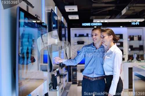 Image of Young couple in consumer electronics store