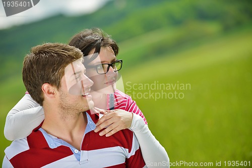 Image of Portrait of romantic young couple smiling together outdoor