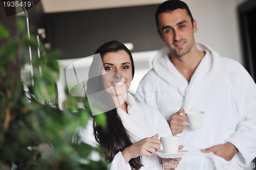 Image of Young love couple taking fresh morning cup of coffee