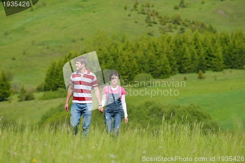 Image of Portrait of romantic young couple smiling together outdoor