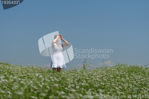 Image of Young happy woman in green field