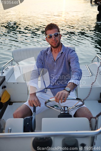 Image of portrait of happy young man on boat