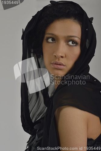 Image of elegant woman in fashionable dress posing in the studio