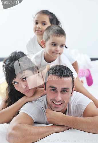 Image of happy young Family in their bedroom