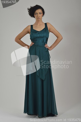 Image of elegant woman in fashionable dress posing in the studio