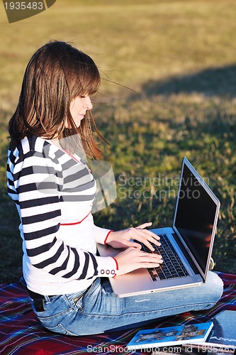 Image of young teen girl work on laptop outdoor