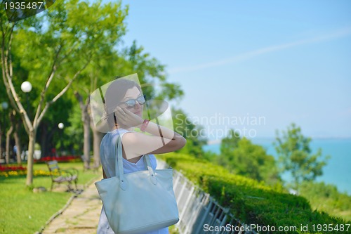 Image of young business woman using mobile phone outdoor