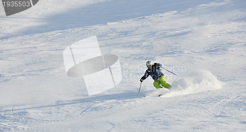 Image of skiing on fresh snow at winter season at beautiful sunny day