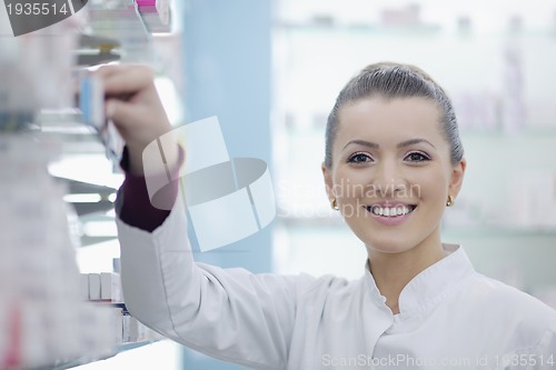 Image of pharmacist chemist woman standing in pharmacy drugstore