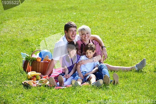 Image of Happy family playing together in a picnic outdoors