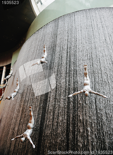 Image of abstract waterfall  with people divers