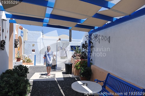 Image of Greek woman on the streets of Oia, Santorini, Greece