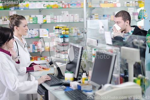 Image of pharmacist suggesting medical drug to buyer in pharmacy drugstor