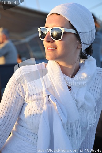 Image of Greek woman on the streets of Oia, Santorini, Greece