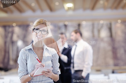 Image of business woman standing with her staff at conference