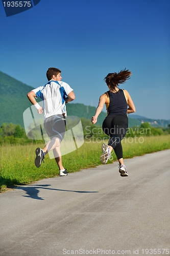 Image of Young couple jogging at morning