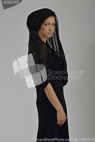 Image of elegant woman in fashionable dress posing in the studio