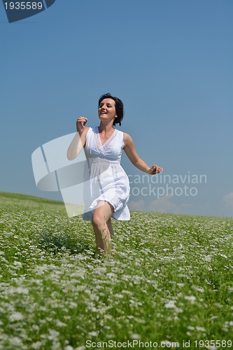 Image of Young happy woman in green field