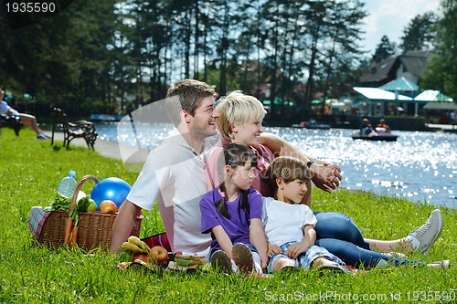 Image of Happy family playing together in a picnic outdoors
