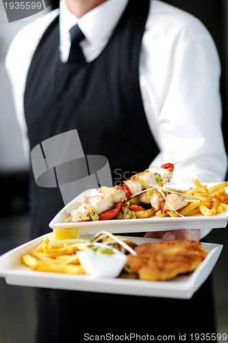 Image of male chef presenting food