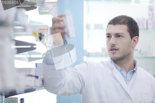 Image of pharmacist chemist man in pharmacy drugstore