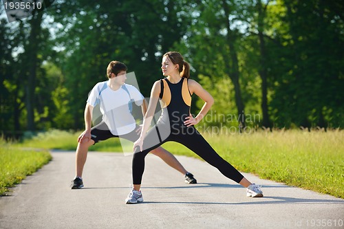 Image of Couple doing stretching exercise  after jogging