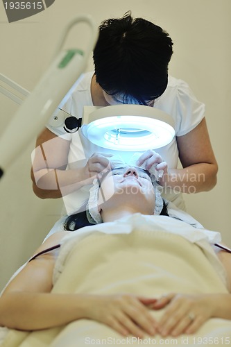 Image of woman with facial mask in cosmetic studio