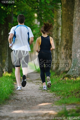 Image of Young couple jogging