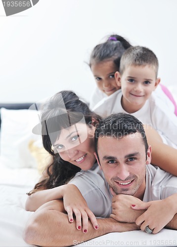 Image of happy young Family in their bedroom
