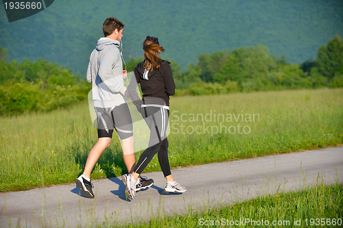 Image of Young couple jogging