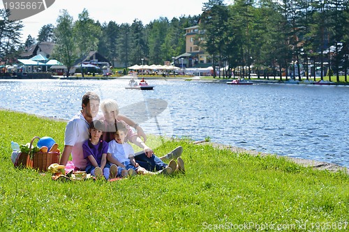 Image of Happy family playing together in a picnic outdoors