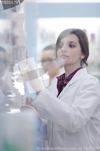 Image of pharmacist chemist woman standing in pharmacy drugstore