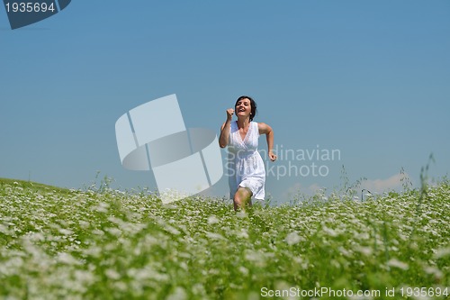 Image of Young happy woman in green field