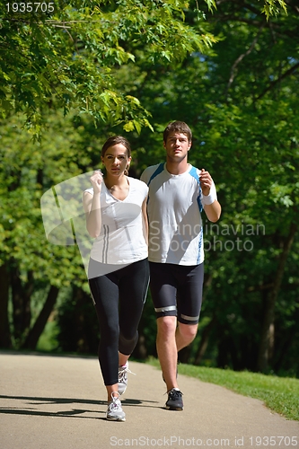 Image of Young couple jogging