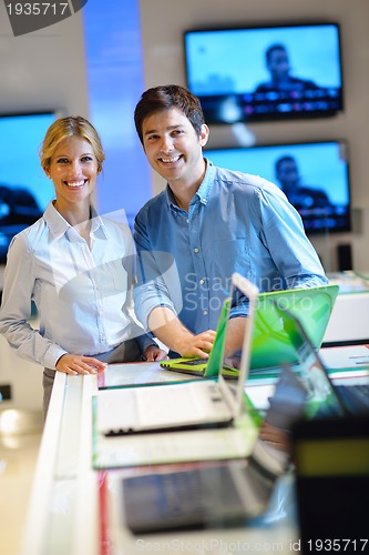 Image of Young couple in consumer electronics store